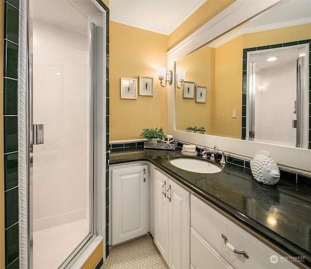 bathroom featuring walk in shower, tile patterned flooring, crown molding, and vanity