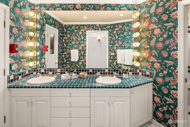 bathroom featuring ornamental molding and vanity