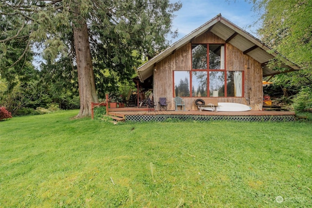 rear view of property featuring a lawn