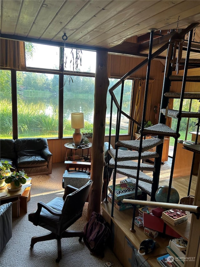 sunroom / solarium featuring wooden ceiling and a water view