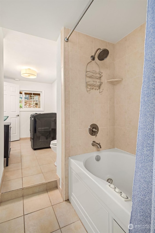 full bathroom featuring shower / bath combination with curtain, toilet, vanity, tile patterned floors, and washer / dryer