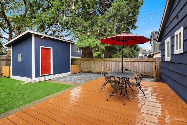 deck featuring a lawn and a shed