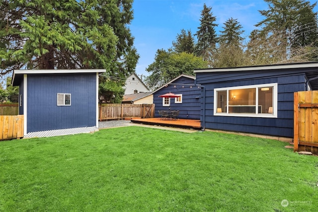 rear view of property with a yard and a wooden deck