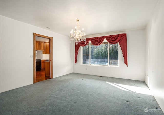 carpeted spare room with a chandelier