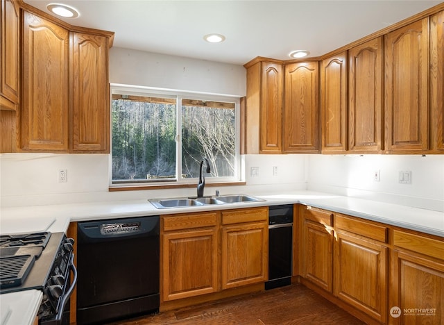 kitchen featuring dark hardwood / wood-style flooring, sink, and black appliances