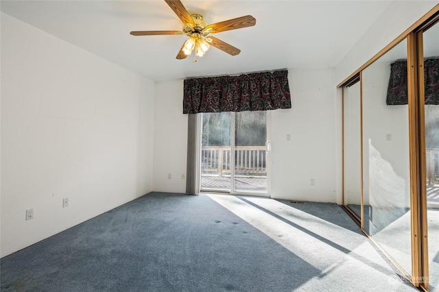 empty room with carpet flooring and ceiling fan