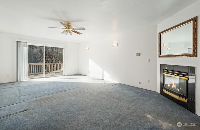 unfurnished living room with carpet, ceiling fan, and a fireplace