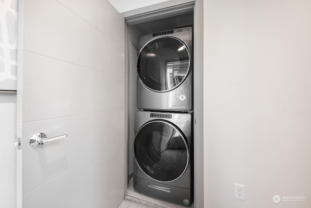 clothes washing area featuring stacked washer / dryer