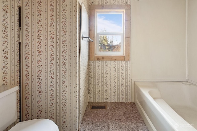 bathroom featuring toilet and a bathing tub