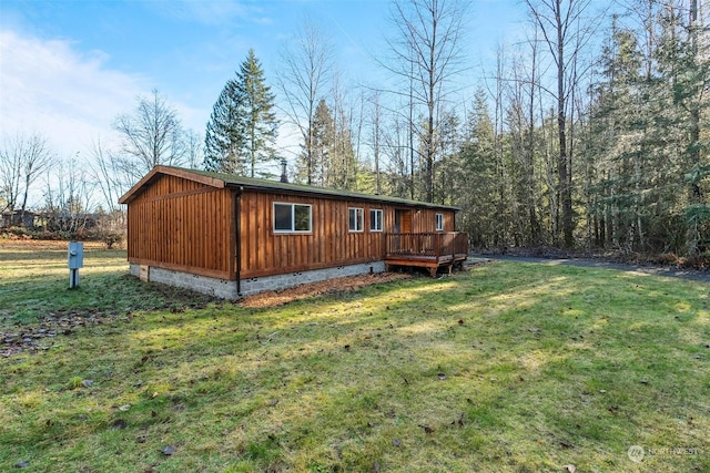 view of home's exterior with a lawn and a wooden deck