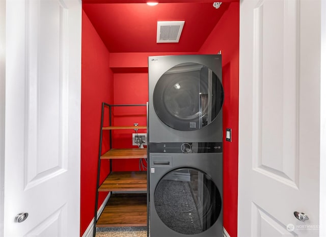 laundry room with stacked washer / drying machine