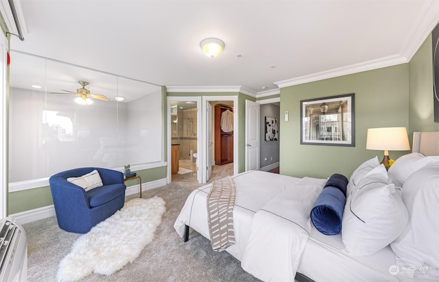 carpeted bedroom with ensuite bathroom, ceiling fan, and ornamental molding