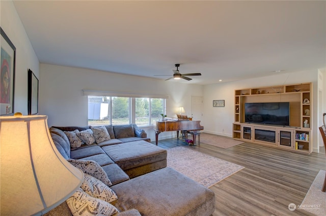 living room featuring hardwood / wood-style floors and ceiling fan