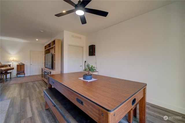 dining area with ceiling fan and dark hardwood / wood-style flooring