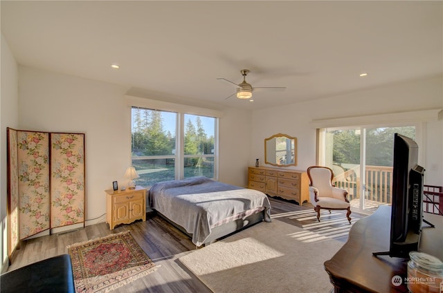 bedroom with wood-type flooring, access to outside, and ceiling fan