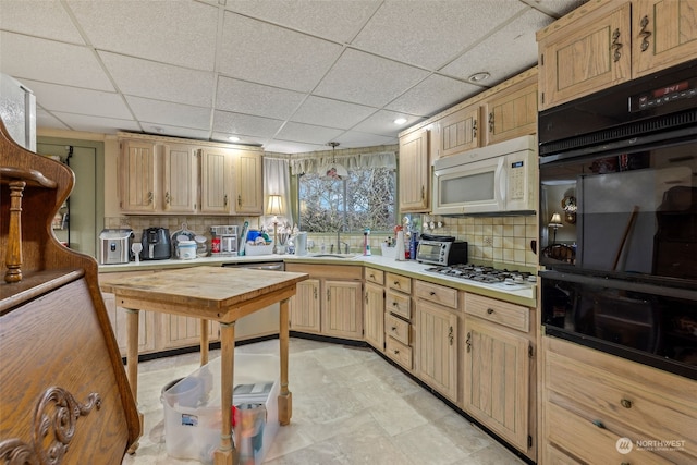 kitchen featuring double oven, sink, decorative backsplash, stainless steel dishwasher, and gas stovetop