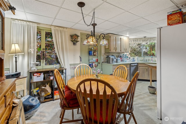 dining room with a paneled ceiling and sink