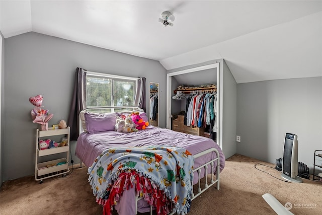 carpeted bedroom featuring vaulted ceiling and a closet