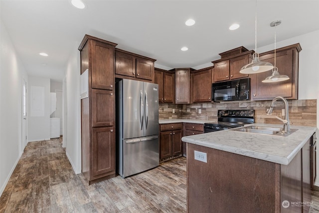 kitchen featuring pendant lighting, black appliances, sink, decorative backsplash, and dark brown cabinets