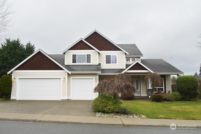 craftsman inspired home with a garage and a front lawn