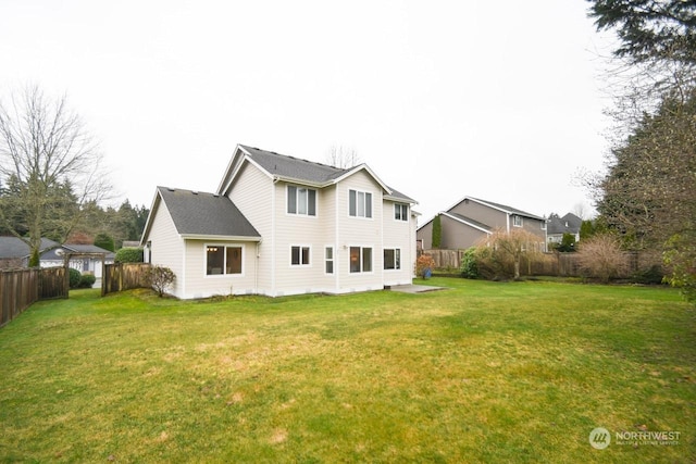 rear view of house featuring a lawn