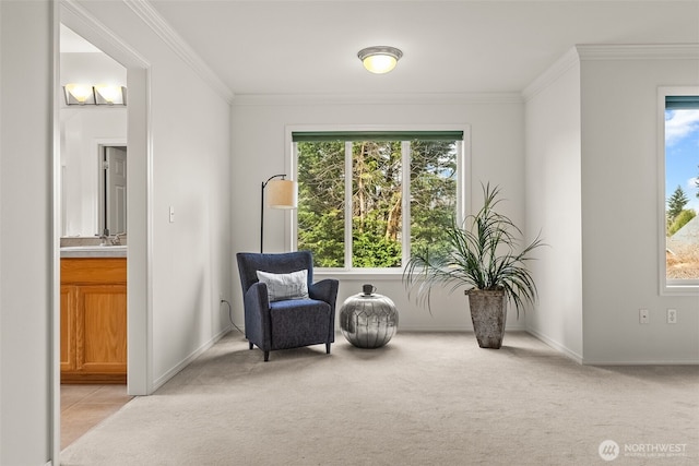 living area with baseboards, crown molding, and light colored carpet