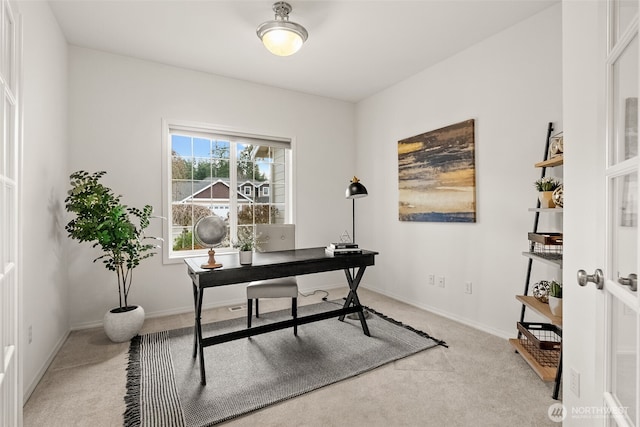 home office with light carpet and baseboards