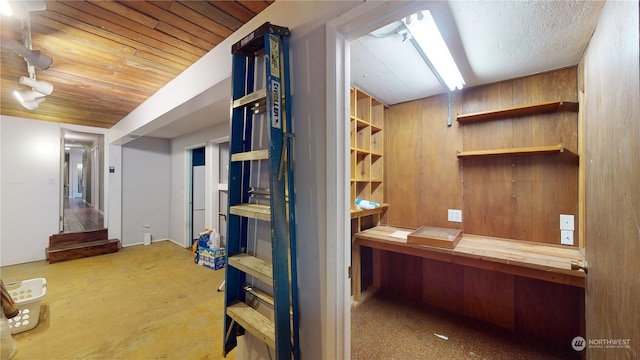 hall featuring wood walls and wooden ceiling