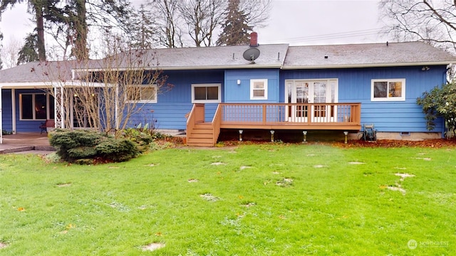 back of house featuring a deck and a lawn