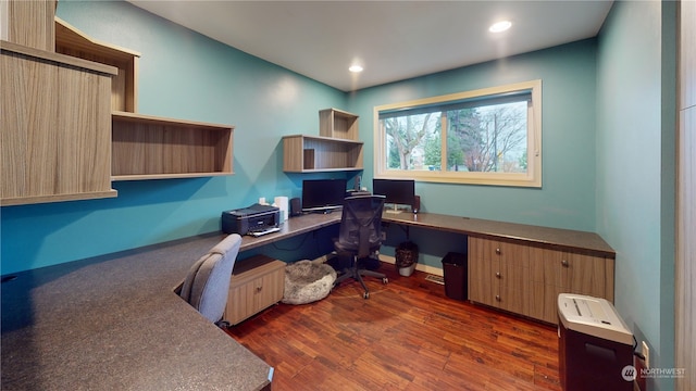 home office with dark hardwood / wood-style floors