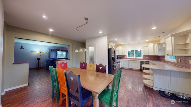 dining area with dark hardwood / wood-style flooring and sink