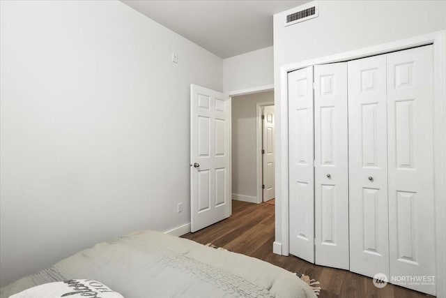 bedroom featuring a closet and dark hardwood / wood-style floors