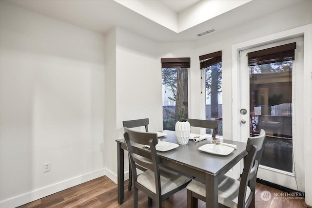 dining space featuring dark wood-type flooring