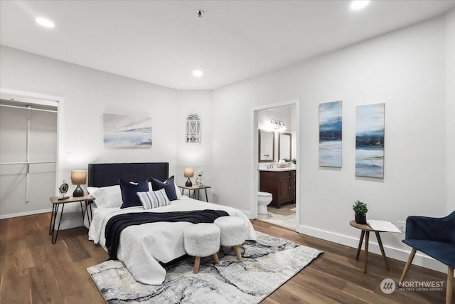 bedroom featuring dark hardwood / wood-style floors and connected bathroom