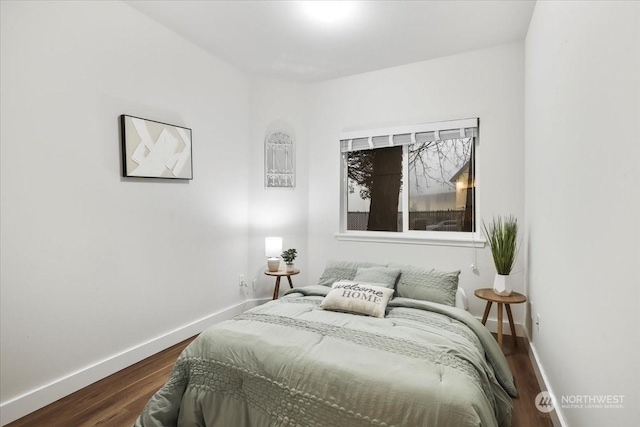 bedroom with dark hardwood / wood-style flooring