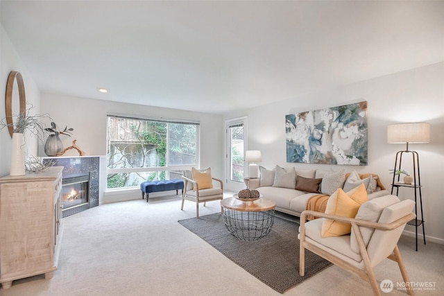 living area with recessed lighting, a tiled fireplace, and light colored carpet