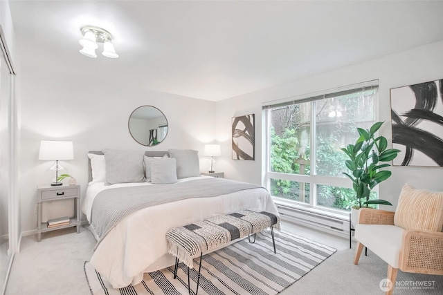 bedroom featuring a baseboard radiator and light carpet