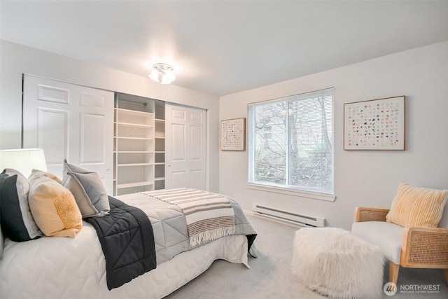 bedroom featuring carpet, a closet, and a baseboard radiator