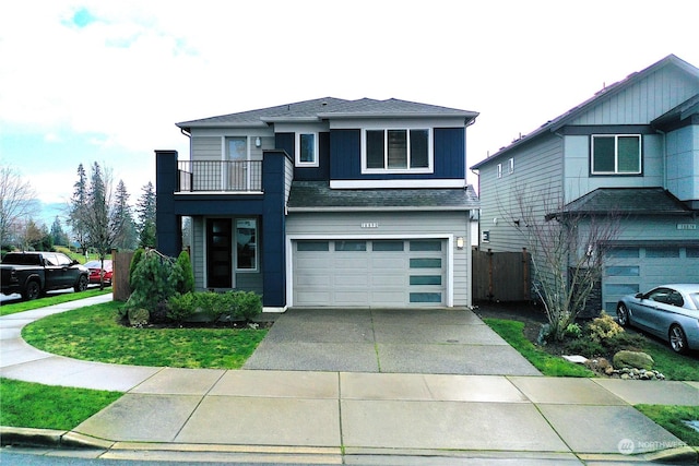 view of front facade with a balcony and a garage