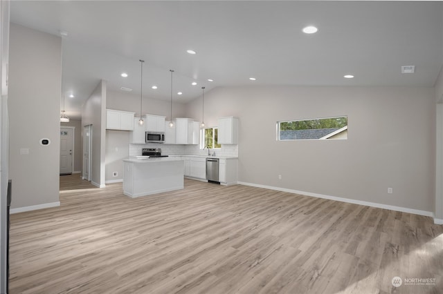 unfurnished living room featuring light wood-type flooring, high vaulted ceiling, and sink