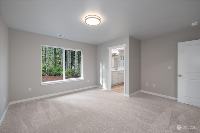 unfurnished room with light colored carpet