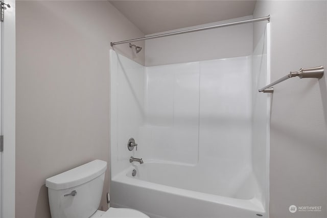 bathroom featuring shower / tub combination and toilet