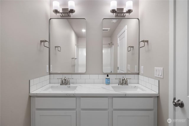 bathroom with a shower and vanity