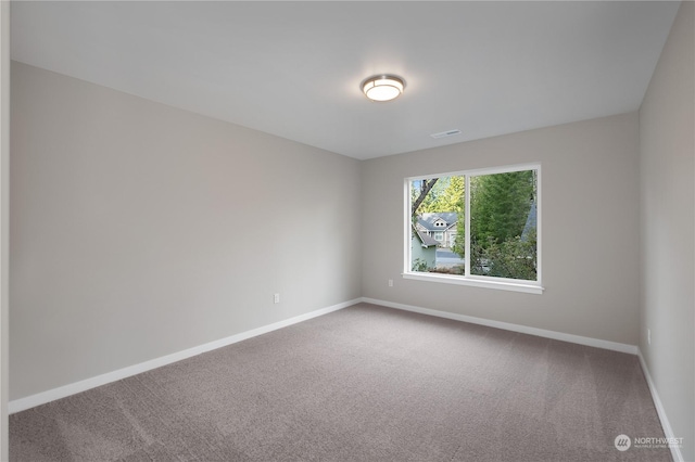 unfurnished room featuring carpet