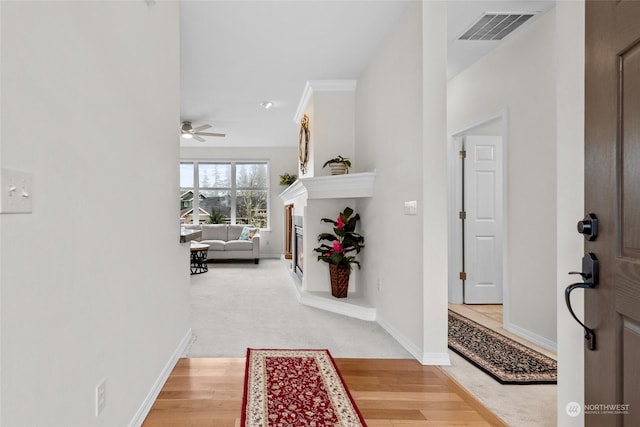 hallway featuring carpet flooring and ornamental molding