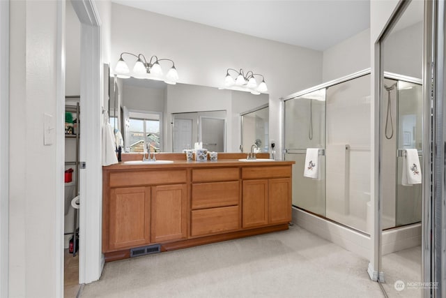 bathroom featuring vanity and a shower with shower door