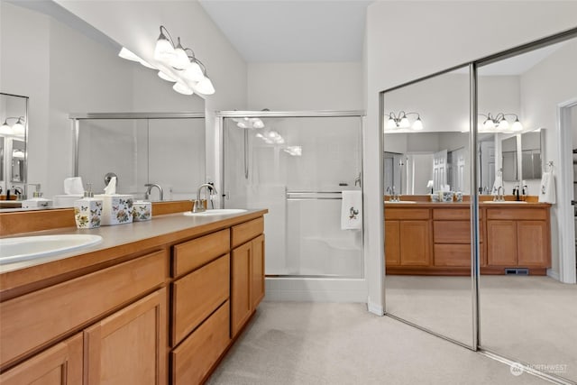 bathroom with walk in shower and vanity