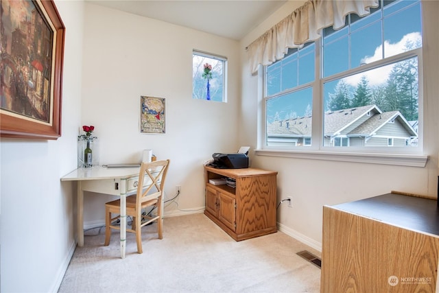 carpeted home office with plenty of natural light