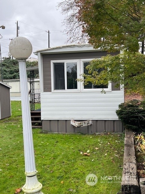 view of side of home with a lawn