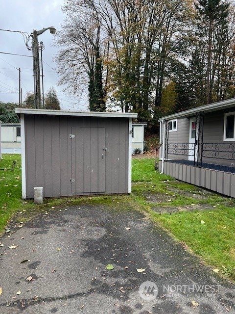 view of outbuilding with a yard